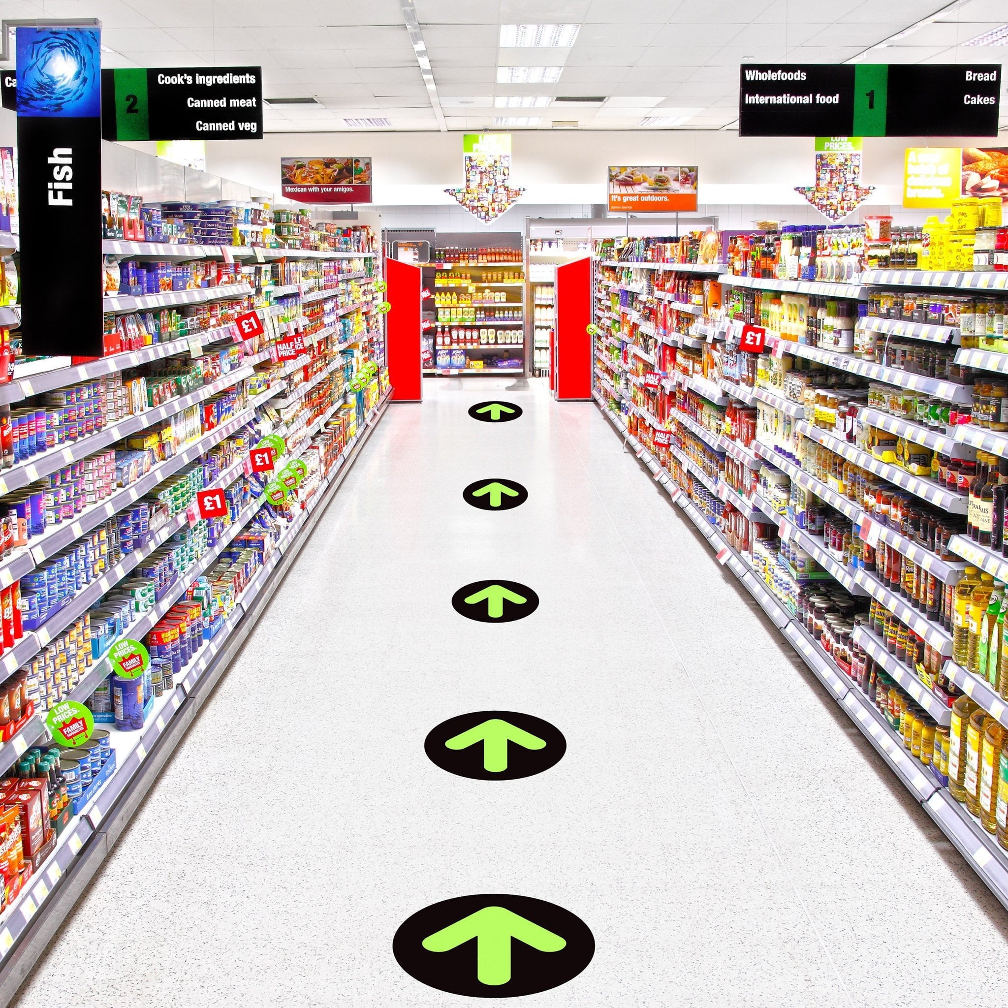 Arrow floor stickers in a grocery market helping to direct customers