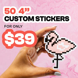 Hand holding a pink pixel-style flamingo vinyl sticker with a white border against a pink marbled background, alongside bold promotional text reading 50 four-inch custom stickers for only $39.