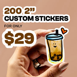Square promotional image with warm tan background featuring bold white and brown text reading 200 2 inch custom stickers for only $29. In the foreground, a hand with neutral nail polish holds a small die cut sticker of a smiling bubble tea cup with black tapioca pearls, blue lid, straw, and orange heart accent.