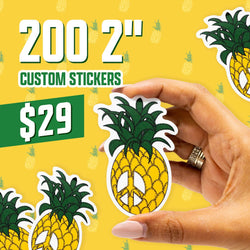Promotional graphic showing text reading 200 2-inch custom stickers and 29 dollars on a bright yellow background patterned with faint pineapple icons. A hand holds a die cut custom vinyl sticker shaped like a pineapple with dark green textured leaves and a bold yellow body featuring a white peace sign. Vibrant, playful aesthetic for waterproof custom stickers and aesthetic decals.