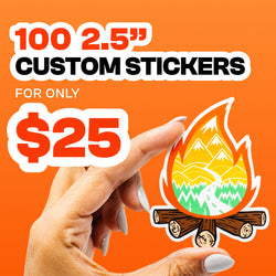 Hand holding a die cut custom vinyl sticker featuring a campfire with mountains, trees, and a winding trail inside the flame design against a bright orange background. Promotional text reads 100 2.5 inch custom stickers for only 25 dollars in bold black and orange lettering