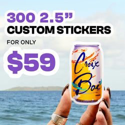 Promotional graphic featuring a hand holding a colorful illustrated sticker of a beverage can in front of an ocean background with soft blue water and cloudy sky. Large purple and white text at the top reads 300 2.5 inch custom stickers and black text beneath says for only. Bold purple price text 59 appears prominently. Bright, playful design style with high contrast and beach atmosphere.