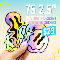 A hand holds several holographic melting smiley-face stickers in rainbow colors. The background resembles a sunny beach scene in soft blue and yellow. On-screen text reads 75 2.5 inch custom iridescent holographic stickers for $29 dollars.