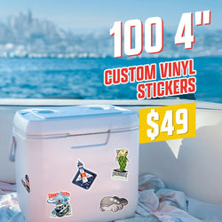 Large white cooler decorated with multiple vinyl stickers in outdoor adventure art styles, including a lighthouse badge, a green fish illustration, a Hammerhead shark graphic, and a whale cartoon. Scene is set on a boat overlooking blue water with a distant city skyline. On-image text reads 100 4 inch custom vinyl stickers and 49. Keywords: outdoor sticker set, adventure illustration decals, coastal vinyl stickers.