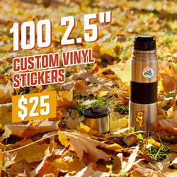 Metal thermos decorated with two vinyl stickers: a colorful All Good circle logo and a cute teddy bear character in a classic cartoon style. Scene is set on an autumn lawn with falling golden leaves. On-image text reads 100 2.5 inch custom vinyl stickers and 25. Keywords: outdoor thermos stickers, cozy fall aesthetic, cute character decal.
