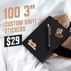 Black notebook decorated with two vinyl stickers: a Sweater Weather text sticker in warm retro script and a pair of desert boots illustrated with simple, hand-drawn shading. Cozy sweaters and blankets surround the scene for a neutral winter aesthetic. On-image text reads 100 3 inch custom vinyl stickers and 29. Keywords: cozy aesthetic sticker set, retro typography decal, western boots sticker.