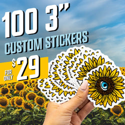 A hand fans out sunflower stickers, each showing a bright yellow sunflower with a blue eye in the center. The background shows a large sunflower field under a blue sky. Promotional text reads 100 3 inch custom stickers for only 29 dollars.