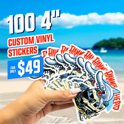 A hand holds a fanned stack of hammerhead shark stickers showing a cartoon shark biting through a tan jeep. The word Hammerhead appears repeatedly in red on the stickers. The background showing a sandy beach and blue ocean. Promotional text reads 100 4 inch custom vinyl stickers for only 49 dollars.