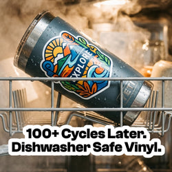 A reusable tumbler with a colorful custom sticker sits inside a dishwasher surrounded by steam and water droplets. The sticker remains intact after extensive washing. Text promotes dishwasher-safe vinyl sticker durability.