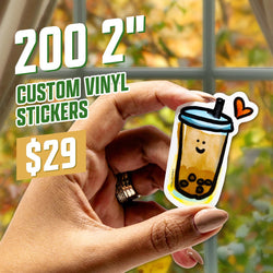 Promotional image featuring a hand holding a small smiling bubble tea sticker with a heart symbol above the cup. Warm autumn foliage appears through a window behind it. Text reads 200 2-inch Custom Vinyl Stickers $29.