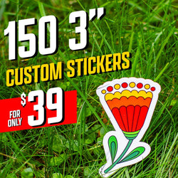 Text on image reads 150 3 inch custom stickers, 39 dollars. A die cut custom vinyl sticker showing a bold folk-art style flower with red and orange petals, yellow dotted trim, and green leaves, placed on bright green grass. Vibrant color palette and simple symmetrical illustration, waterproof aesthetic decal for outdoor or nature themes.