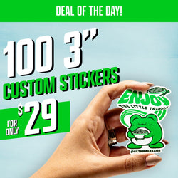 Promotional image with a hand holding a die-cut green frog sticker eating noodles, with stylized text that reads Enjoy the Little Things. Blue sky background. Promotional header reads Deal of the Day. Additional text reads 100 3 inch custom stickers for only $29.