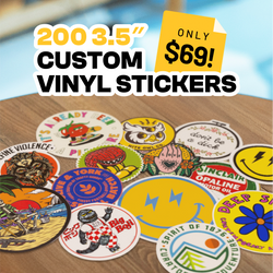 200 3.5 inch custom vinyl stickers, 69 dollars. A spread of round die cut stickers featuring cartoon fruits, owls, smiley faces, floral art, retro labels, animals, and brewery logos on a wood table. Bright mixed aesthetics, waterproof custom decals.