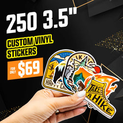 Hand holding three die-cut hiking and outdoors themed stickers: Happy Camper with a mountain and tent, an Alaska badge with a bear, and a Take a Hike sticker shaped like a boot with flames. Black geometric background with yellow accents. On-image text reads 250 3.5 inch custom vinyl stickers for $69. Keywords: adventure stickers, national park decals, hiking badge stickers.
