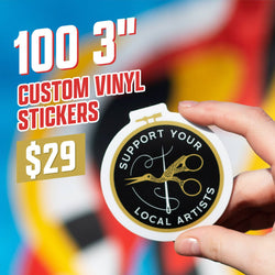 Hand holding a round vinyl sticker featuring gold scissors forming a humming bird shape with a needle and thread, surrounded by the printed text Support Your Local Artists. Colorful blurred background. On-image text reads 100 3 inch custom vinyl stickers for $29. Highly relevant keywords include artist stickers, craft stickers, handmade business decals.