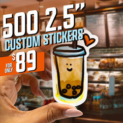 Promotional graphic for 500 2.5 inch custom vinyl stickers for 89 dollars, featuring a hand holding a cute die cut waterproof sticker of a smiling boba tea cup with a heart doodle. Background shows a blurred café interior. Text highlights deal pricing in bold white, blue, and orange typography for high visibility.