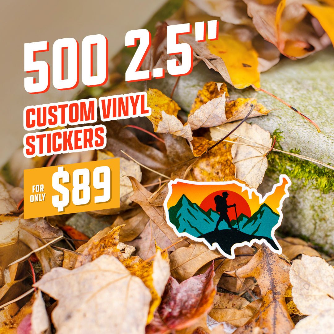 Text reads 500 2.5 inch custom vinyl stickers, 89 dollars. A die cut sticker shaped like the United States shows a hiker silhouette against orange sunset and teal mountains, placed on autumn leaves. Outdoor adventure aesthetic, waterproof vinyl decal.