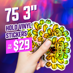 Promotional graphic for 75 three-inch holographic vinyl stickers for twenty-nine dollars. A hand holds a fanned stack of holographic vibrant, tribal-inspired face sticker with a symmetrical mask design in yellow, green, and gold tones. The face features geometric shapes, dark eye details, and layered feather-like elements around it. Background is a multicolor blurred gradient.