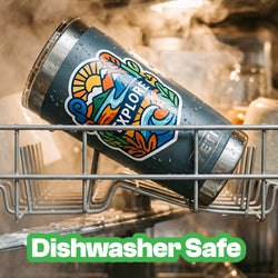 A dark gray insulated tumbler with a colorful 'EXPLORE' logo, shown inside a dishwasher rack with steam and water droplets. A green text overlay at the bottom reads 'Dishwasher Safe'.