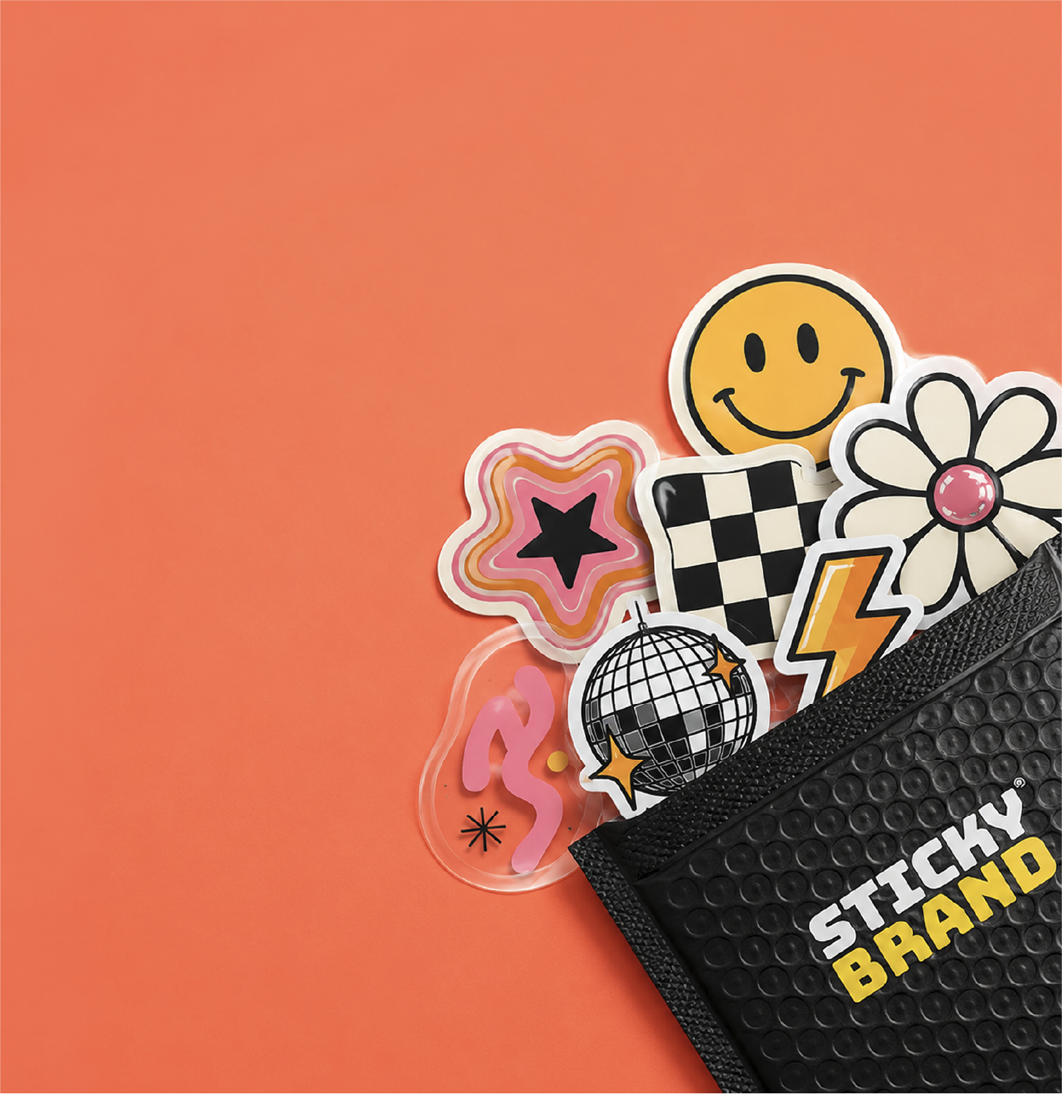 A black textured pouch with 'STICKY BRAND' printed in white and yellow sits on a solid orange background, partially filled with colorful novelty stickers including a smiley face, disco ball, flower, checkered flag, pink star, and lightning bolt.