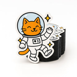Stack of custom fridge magnets with a cat in an astronaut suit design on a white background