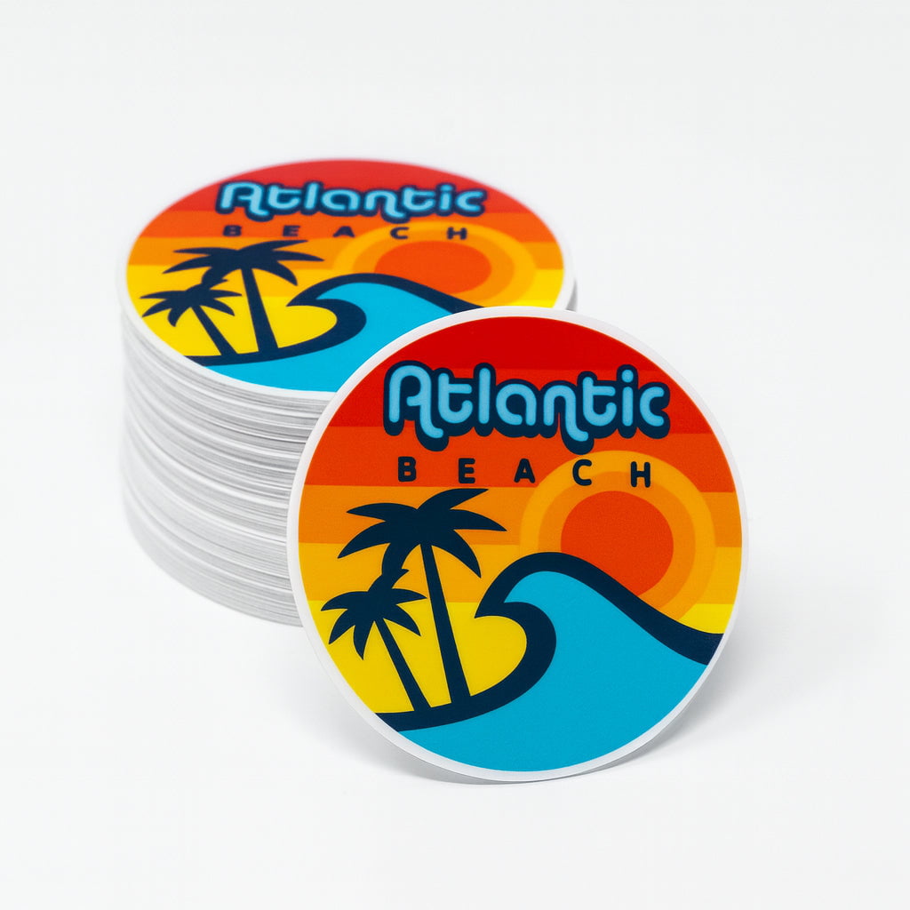 Stack of 'Atlantic Beach' circle stickers with a retro design featuring palm trees and waves on a white background.