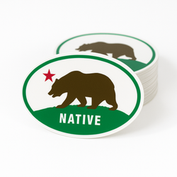 Stack of oval stickers with bear and star design on a white background