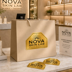 A custom brushed gold metallic sticker is applied to a luxury shopping bag at a skincare boutique. The sticker reads 