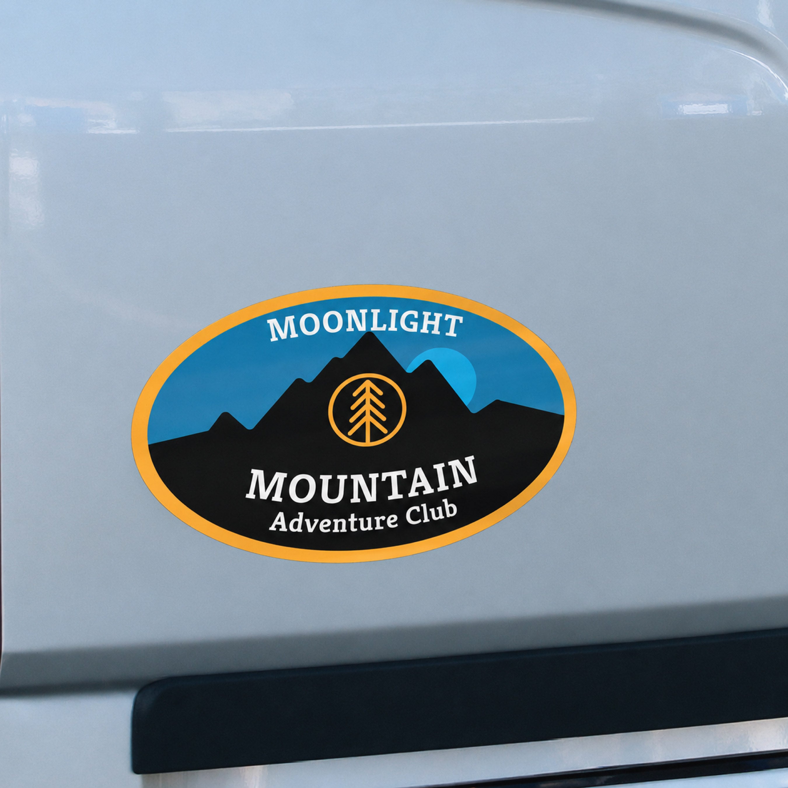 An oval custom refrigerator magnet features a mountain landscape with the text "MOONLIGHT MOUNTAIN Adventure Club." The full-color magnet demonstrates custom promotional magnets for outdoor brands, clubs, events, tourism, and adventure organizations.
