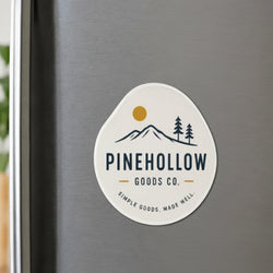 A rounded custom refrigerator magnet displays the logo and text 