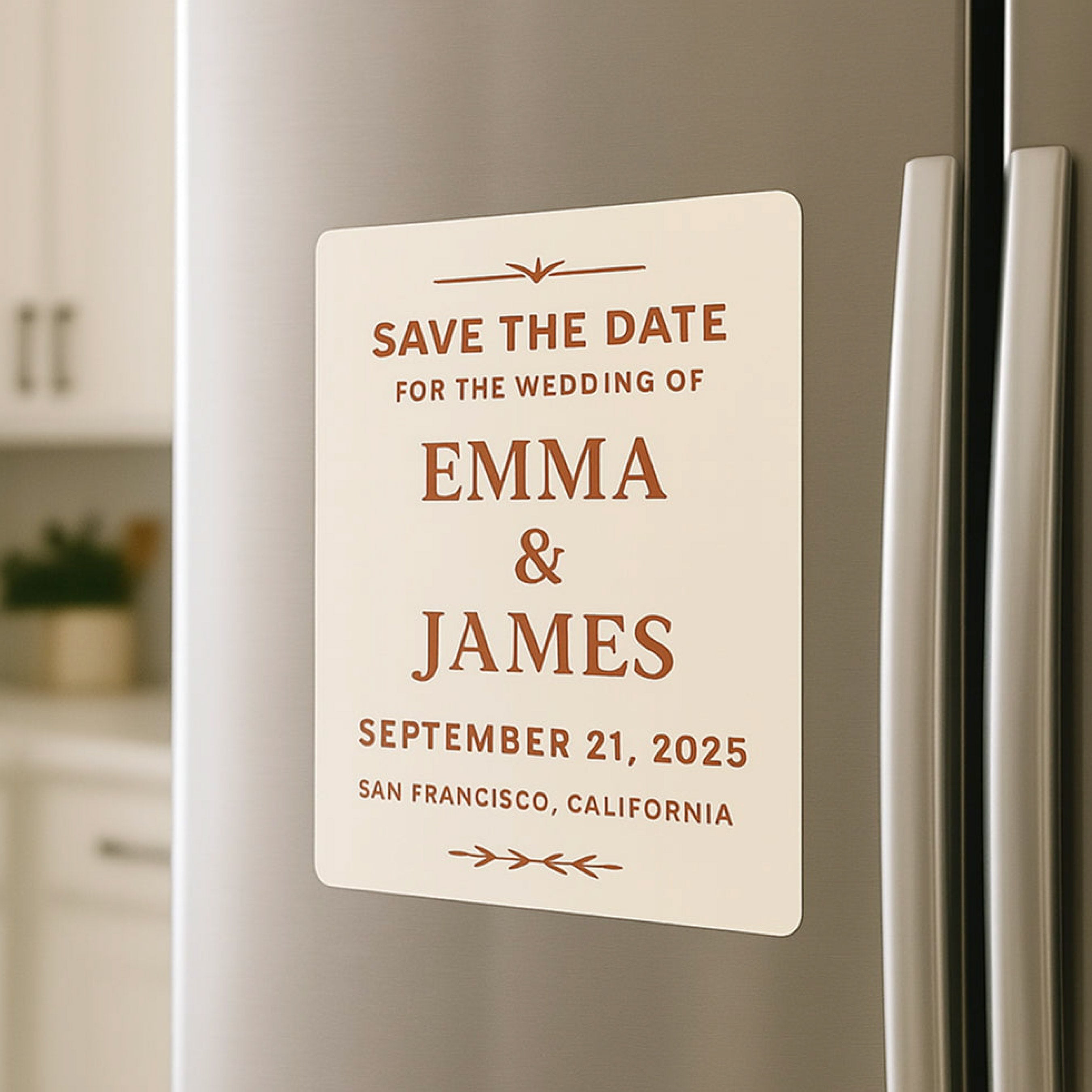 A square save-the-date refrigerator magnet displays the text "SAVE THE DATE," "FOR THE WEDDING OF," "EMMA & JAMES," "SEPTEMBER 21, 2025," and "SAN FRANCISCO, CALIFORNIA." The magnet demonstrates custom wedding announcement magnets designed as keepsakes and event reminders.