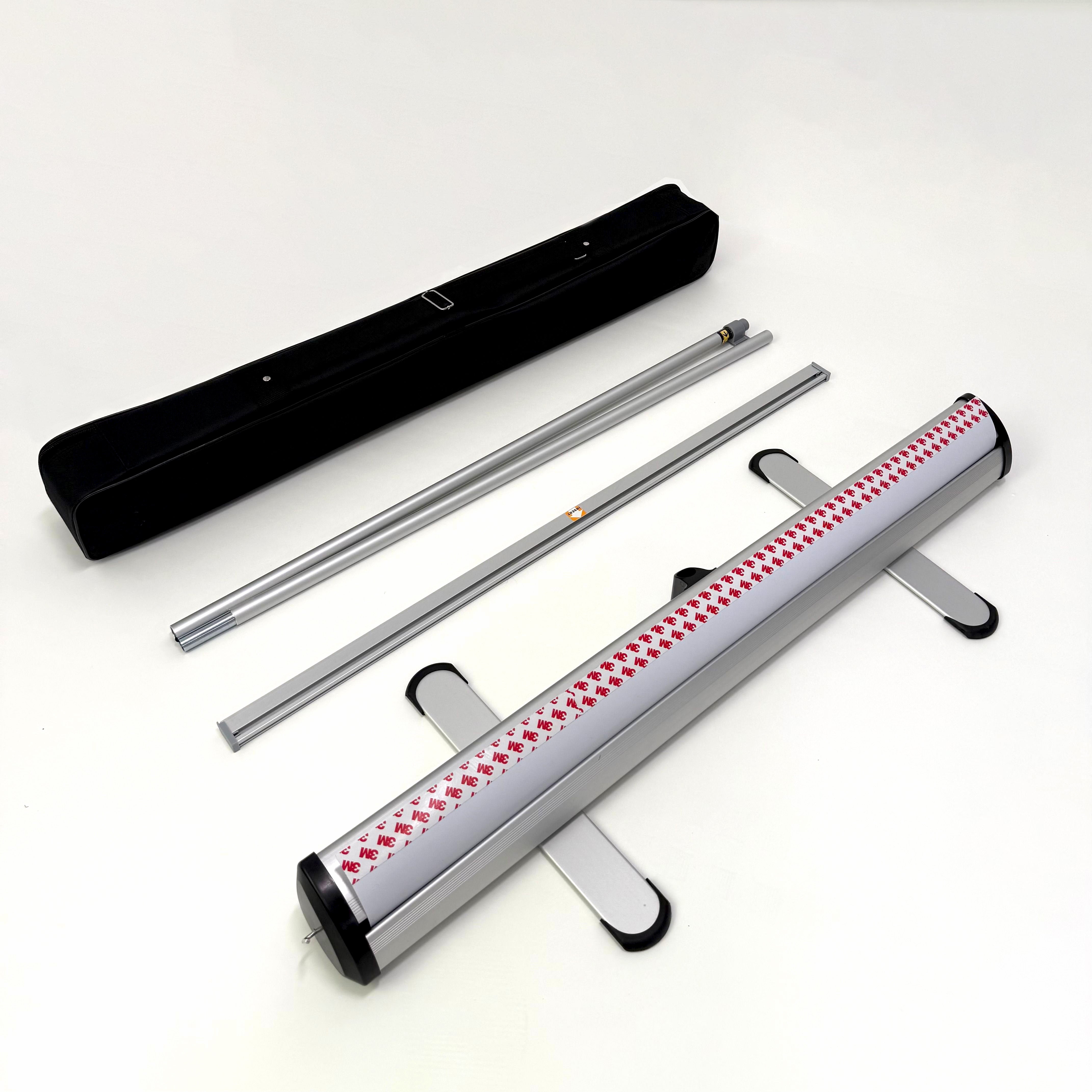 Image shows Banner stand package content black carry case aluminum pole stand and retractable base with protective edge feet