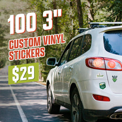 White SUV parked on a forest road with several outdoor-themed stickers on the rear, including a canoe graphic, a mountain landscape badge, and a green hop-shaped Viking helmet logo. On-image text reads 100 3 inch custom vinyl stickers for $29. Keywords: car bumper stickers, outdoor decals, adventure vinyl stickers.