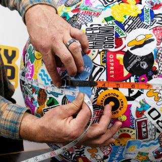 Adding stickers to the largest sticker ball in history