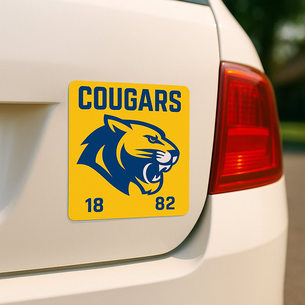 Cougers sports team magnet blue white graphic on yellow background placed on white car for fan promotion. Text reads. Cougars. 1882