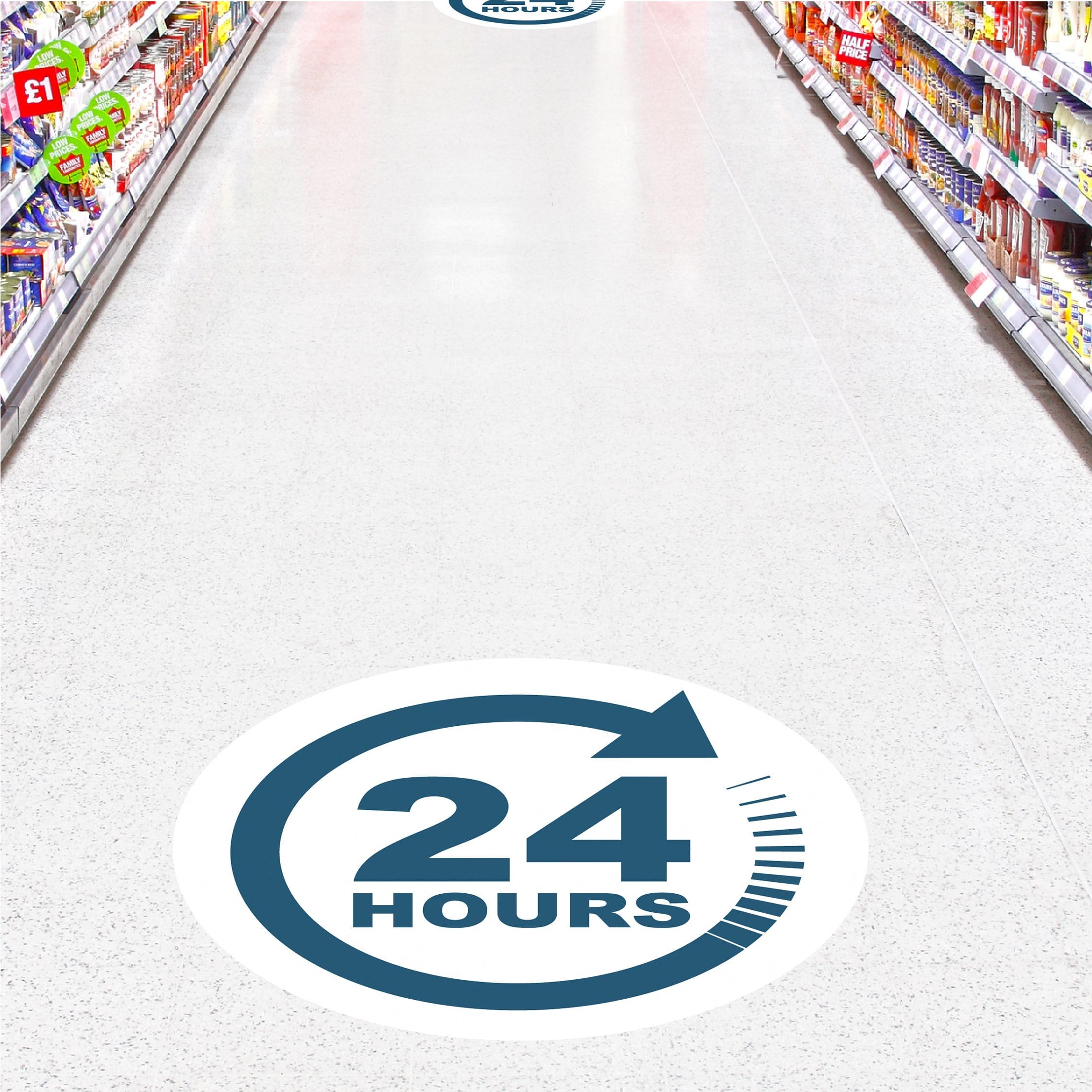 Blue and White Floor Sticker Graphic with text. 24 Hours with circular blue arrow to represent store open around the clock. Stickers on ceramic tile floor in grocery store aisle.