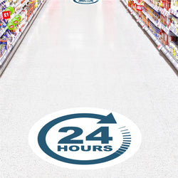 Blue and White Floor Sticker Graphic with text. 24 Hours with circular blue arrow to represent store open around the clock. Stickers on ceramic tile floor in grocery store aisle.