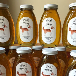 Nina's honey roll labels on a jar of honey