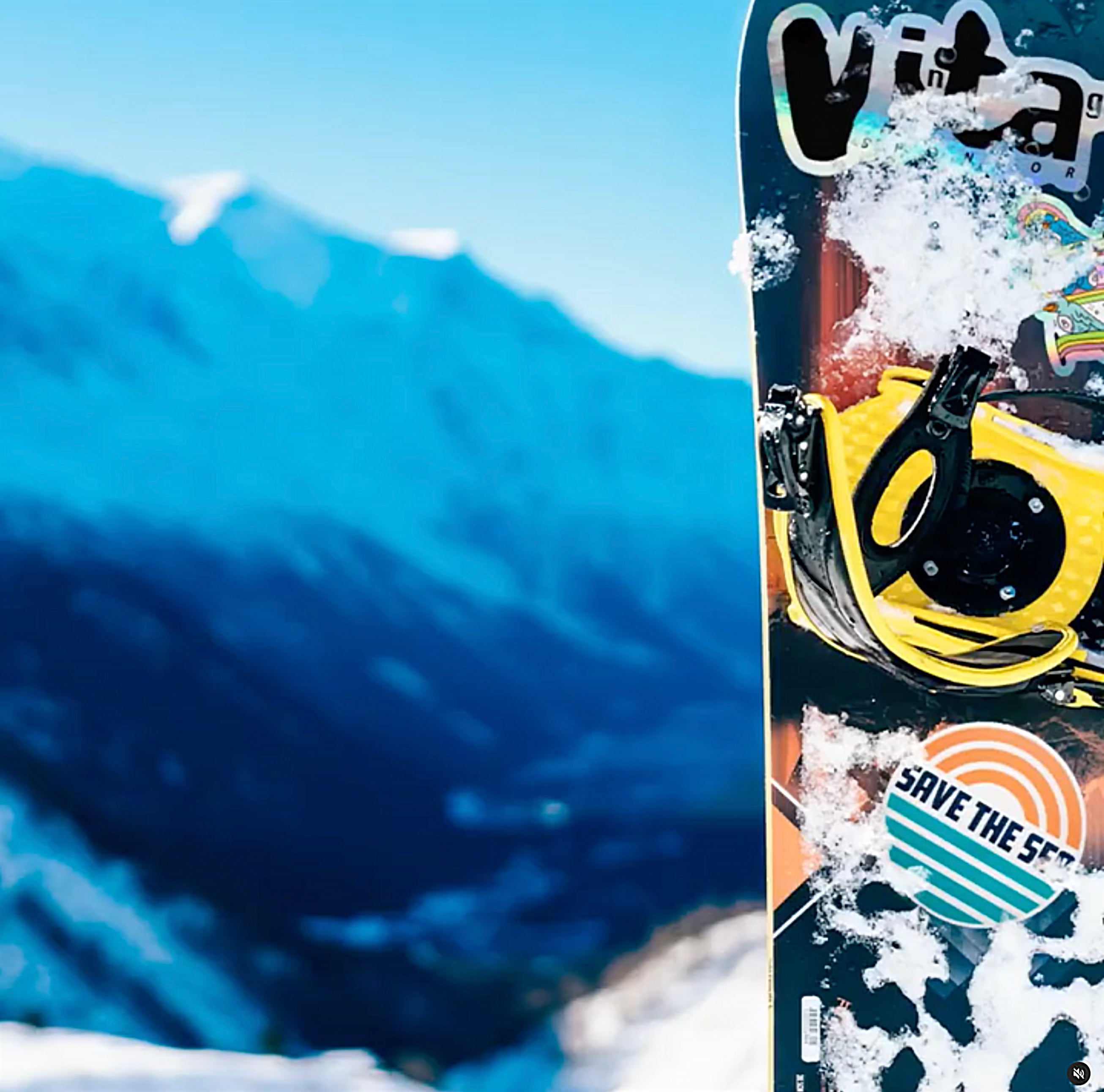 Snowboard rockin various snowboard stickers on a mountain